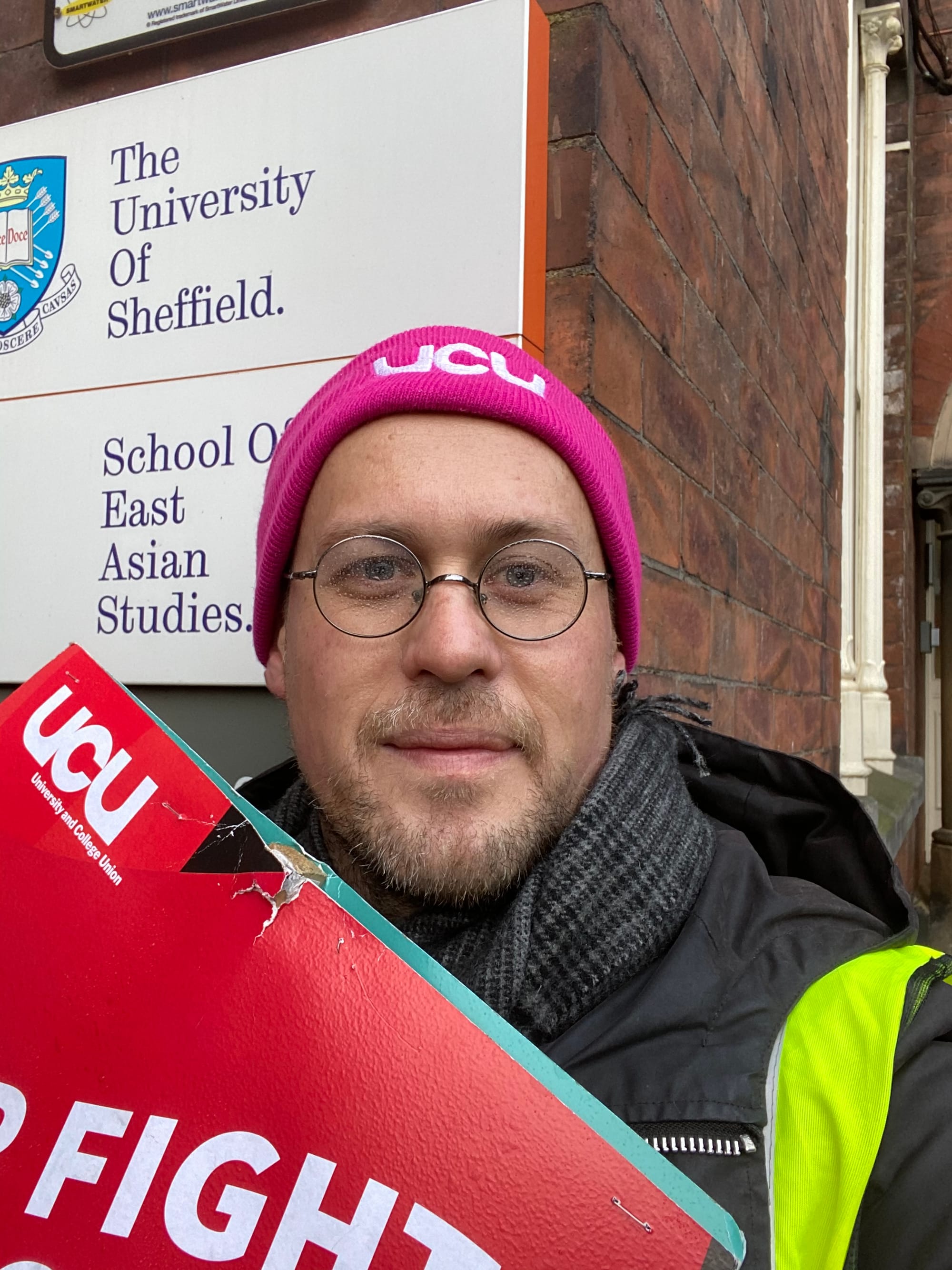Mark wearing a UCU hat and holding a placard