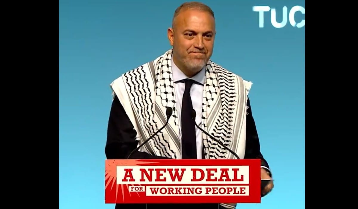 Photo of Hussam Zomlot, the Palestinian Ambassador to the United Kingdom, behind a TUC podium with the words 'A New Deal for